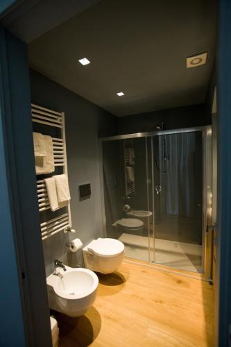 a bathroom with a toilet and a sink and a shower at Villa Fornari Resort in Bisceglie