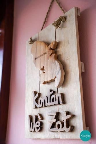 a sign hanging on a wall with the word kronoa at Villa Noëlyne in Le Robert