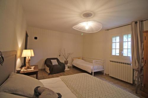 a bedroom with two beds and a large window at La maison de claire in Saint-Ouen-sur-Gartempe