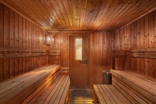 an empty wooden sauna with benches and a window at Savoy Spa & Kurhotel in Františkovy Lázně