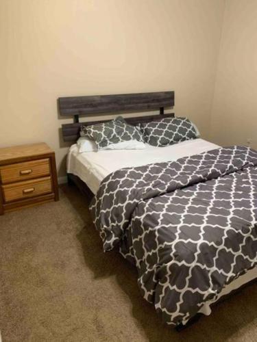 a bedroom with a black and white bed and a nightstand at 290/Cypress/NW Houston/Pets/NewListing in Cypress