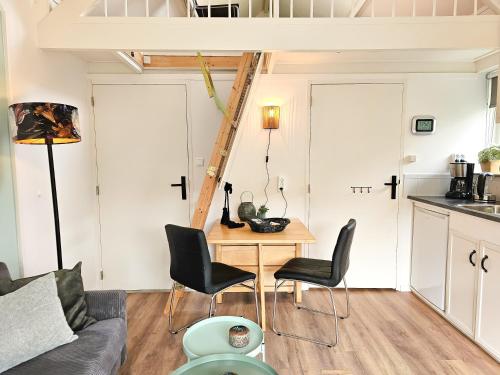 a small living room with a table and chairs at Vakantiehuis Gapinge GA03 met omheind terras in Gapinge