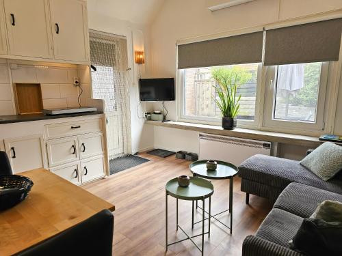 a living room with a couch and a table at Vakantiehuis Gapinge GA03 met omheind terras in Gapinge