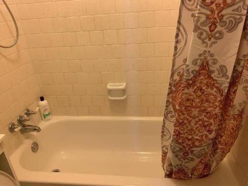 a bathroom with a bath tub with a shower curtain at 290/Cypress/NW Houston/Pets/NewListing in Cypress