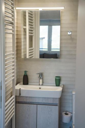 a bathroom with a sink and a mirror at Emmanouela View Apartment in Koutsélion