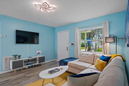 a living room with a couch and a table at Sunny Days and Starry Nights in Pinellas Park