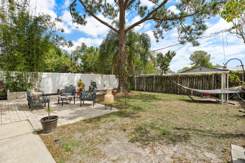 a patio with a hammock in a backyard at Sunny Days and Starry Nights in Pinellas Park