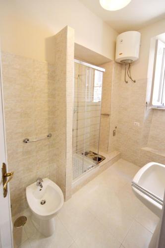 a bathroom with a shower and a toilet and a sink at Casa Vacanze Rocca dei Papi in Montefiascone