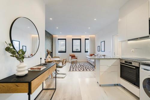 a kitchen with a large mirror and a living room at GuestReady - Cozy place in Matosinhos in Matosinhos