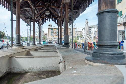 a building with a bunch of pillars and water at Frontemare in Savona