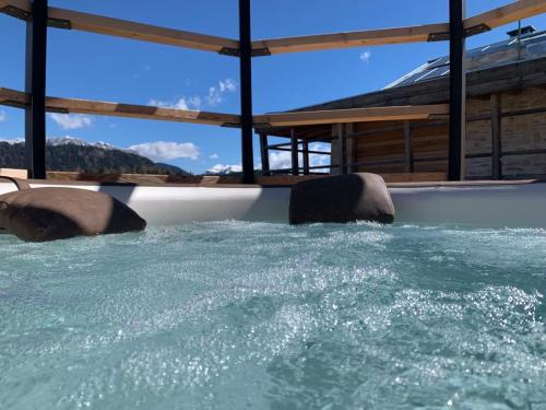 a large pool of water with rocks in it at Maso Stella in Castello Tesino