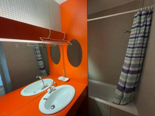La salle de bains orange est pourvue d'un lavabo et d'une douche. dans l'établissement Appart 2 pièces au pied des pistes, balcon, 6 pers, Les Adrets - FR-1-557-105, à Les Adrets