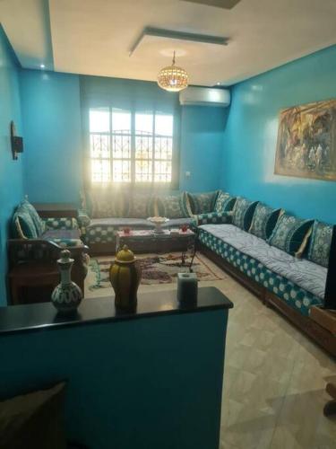 a living room with a couch and a table at Tamraght 3 Bedroom Apt with Oceanview 2.Level in Tamraght Oufella