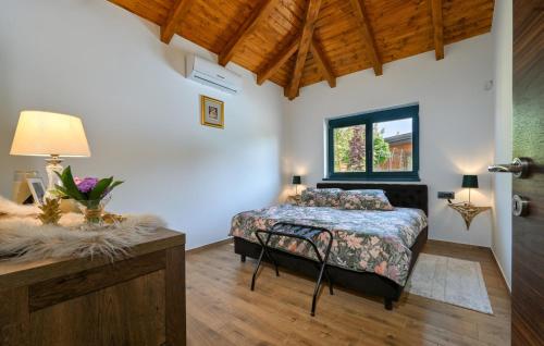a bedroom with a bed and a table and a window at Gorgeous Home In Puscine With Sauna in Varaždin