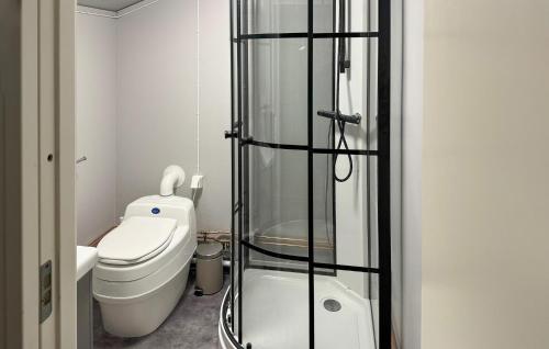 a bathroom with a toilet and a glass shower at Beautiful Home In ml With Kitchen in Åmål