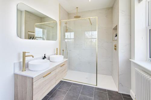 a bathroom with two sinks and a shower at Host & Stay - Finch House in Stokesley