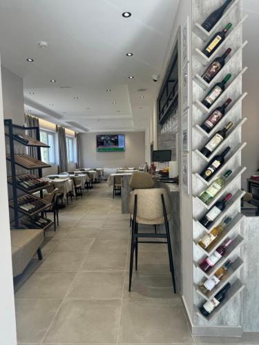 a wine tasting room with chairs and wine bottles at Hotel Kseal in Përmet