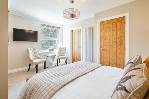 a bedroom with a bed and a table and chairs at Host & Stay - Finch House in Stokesley