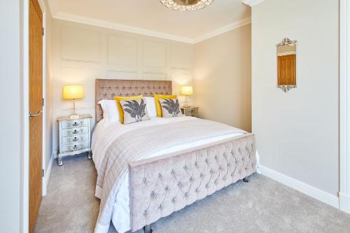 a bedroom with a large bed with yellow pillows at Host & Stay - Finch House in Stokesley
