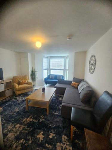 a living room with a couch and a coffee table at Seaside Haven Coastal Comfort 200m from the Beach in Kent