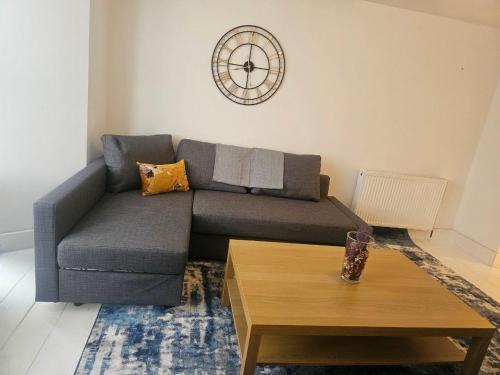 a living room with a couch and a coffee table at Seaside Haven Coastal Comfort 200m from the Beach in Kent