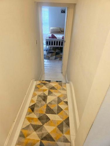 a room with a hallway with a carpeted floor at Seaside Haven Coastal Comfort 200m from the Beach in Kent