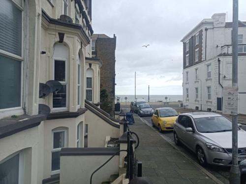 a street with cars parked on the side of a building at Seaside Haven Coastal Comfort 200m from the Beach in Kent