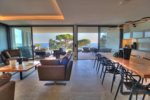 un salon avec une table et des chaises dans l'établissement Blue Diamond - 8 personnes - 5*, aux Issambres