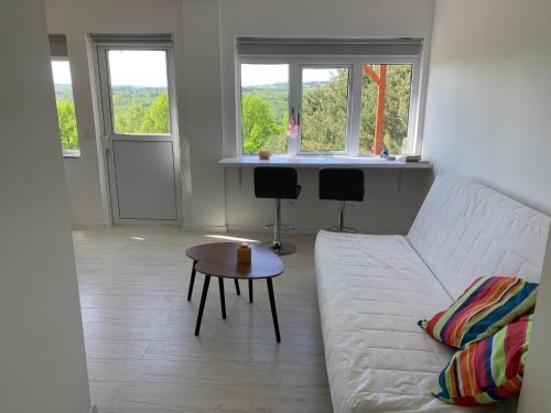 a living room with a white couch and a table at Gwiezdna łąka 