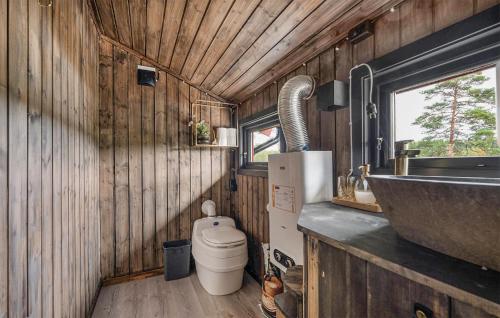 a small bathroom with a toilet and a sink at Stunning Home In Setskog With Lake View 