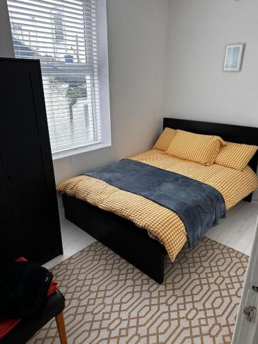 a bedroom with a bed and a window at Seaside Haven Coastal Comfort 200m from the Beach in Kent