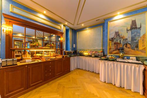 a buffet line with white tables in a restaurant at Hotel Kinsky Fountain in Prague