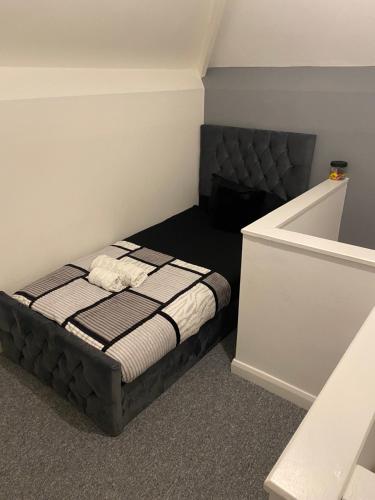 a small bedroom with a bed and a bath tub at Cosy Home In Nottingham Near QMC and University Free Parking! in Nottingham
