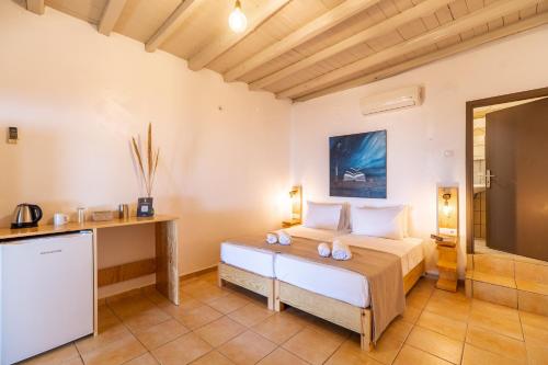a bedroom with a bed and a tv in a room at Mylos Seaside Experience in Frangokastello