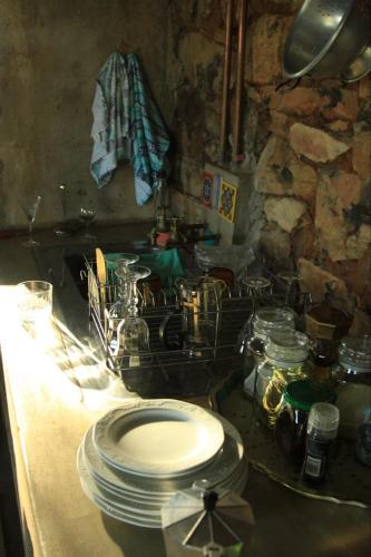a kitchen with a stove with plates on a counter at Kwaggaskop Farm Kliphuis in Dullstroom