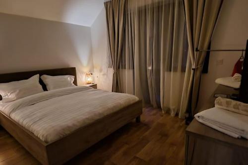 a bedroom with a large bed and a window at MountainView Home in Codlea