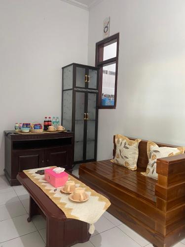 a living room with a couch and a table at Griya Indah Homestay in Pacet