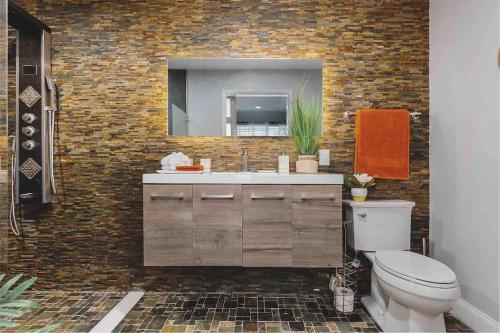 a bathroom with a toilet and a mirror at Shoreline Splendor Luxury 4 Bedroom Escape in Atlantic City in Atlantic City