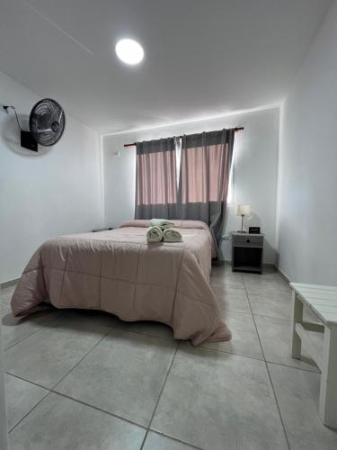 a bedroom with a bed in a white room at Hotel Los Angeles in Santa Teresita