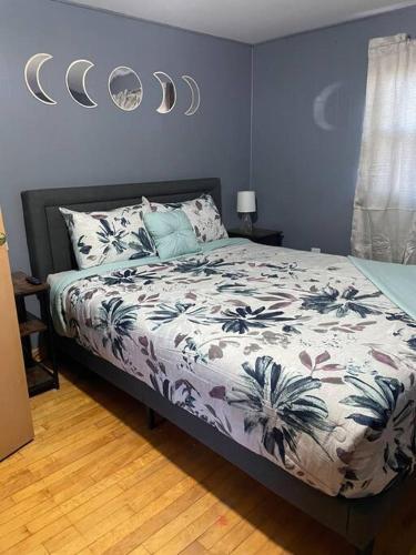 a bedroom with a bed with a comforter on it at Beautiful Trailside Haven on the Edge of Town in Hibbing