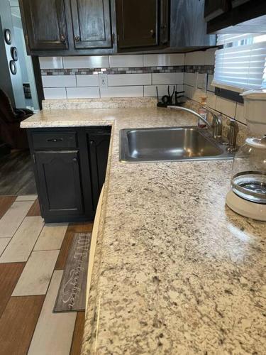 a kitchen with a sink and a counter top at Beautiful Trailside Haven on the Edge of Town in Hibbing