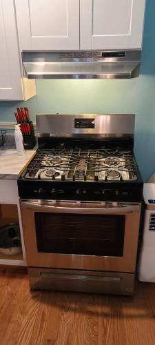 a stove top oven sitting in a kitchen at Private 1 Bedroom in Boston in Boston
