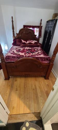 a bed in a room with a wooden floor at Private 1 Bedroom in Boston in Boston