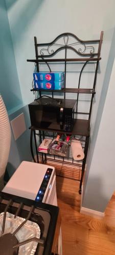 a shelf with a computer on it in a room at Private 1 Bedroom in Boston in Boston