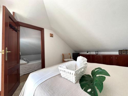 a bedroom with a bed with a plant on it at Betula Pendula - 12601 in Ajo