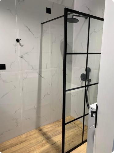 a bathroom with a shower with white marble walls at Barbati breathtaking views in Barbati
