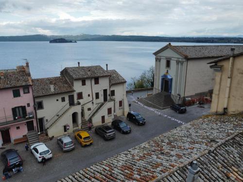 a view of a town with cars parked in a parking lot at la rocca sul lago in Capodimonte