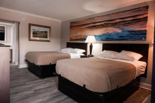 A bed or beds in a room at Riverside Inn and Suites