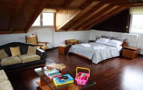 a bedroom with a bed and a living room at Meliti Villa in Píla