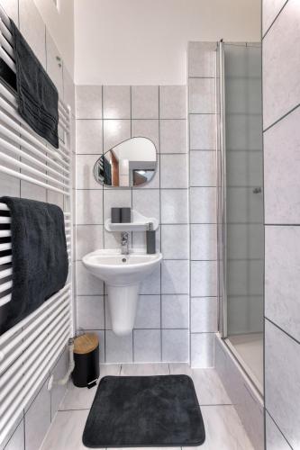 a white bathroom with a sink and a shower at FAUNAPARK Lipová-lázně in Lipova Lazne
